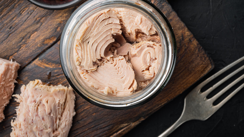 canned tuna on a cutting board