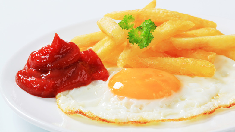 fried eggs, fries, and ketchup