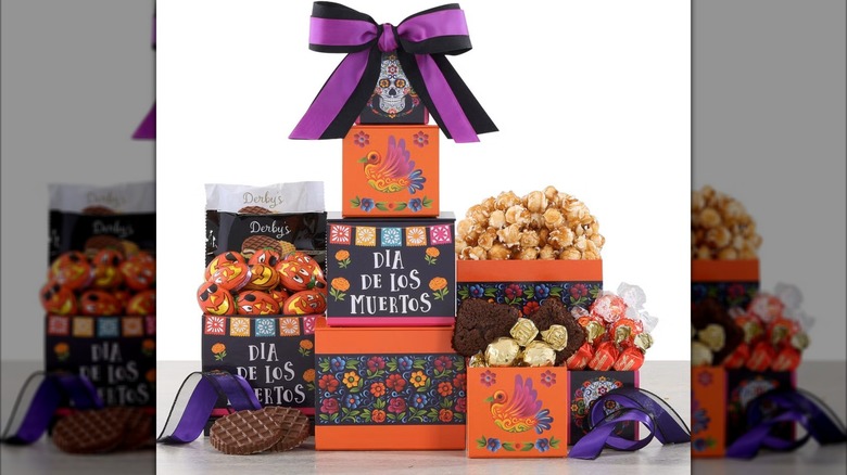 Dia de los muertos themed gift box with candy, popcorn, and other treats.
