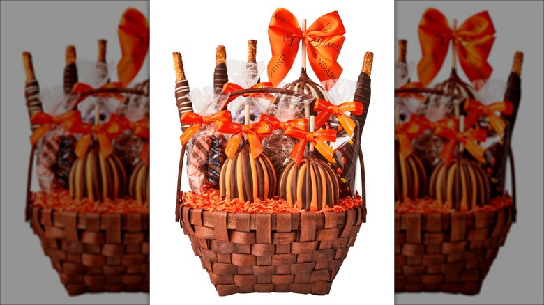 Halloween themed gift basket with caramel apples and other treats.