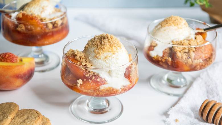 peach crumbles in serving dishes with ice cream