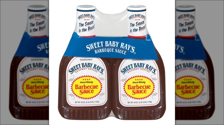 Two bottles of barbecue sauce in plastic packaging.