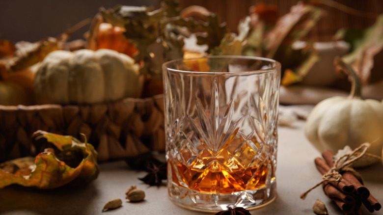 A glass of cognac on a table with rustic decorations