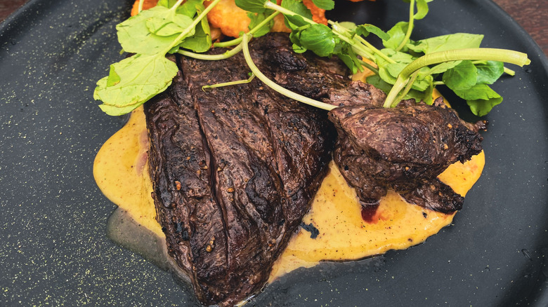 Steak and hollandaise sauce and a fresh garnish