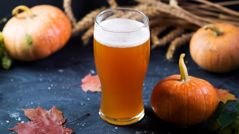 Pint of beer by pumpkin