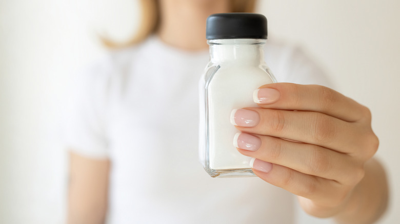 Woman holding salt shaker