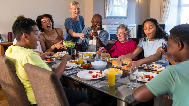 A large family sitting at a dinner table