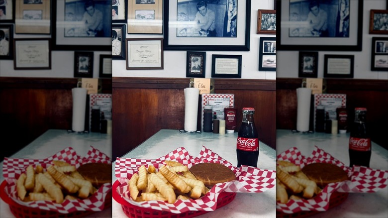 Burger, fries, and Coke on diner table