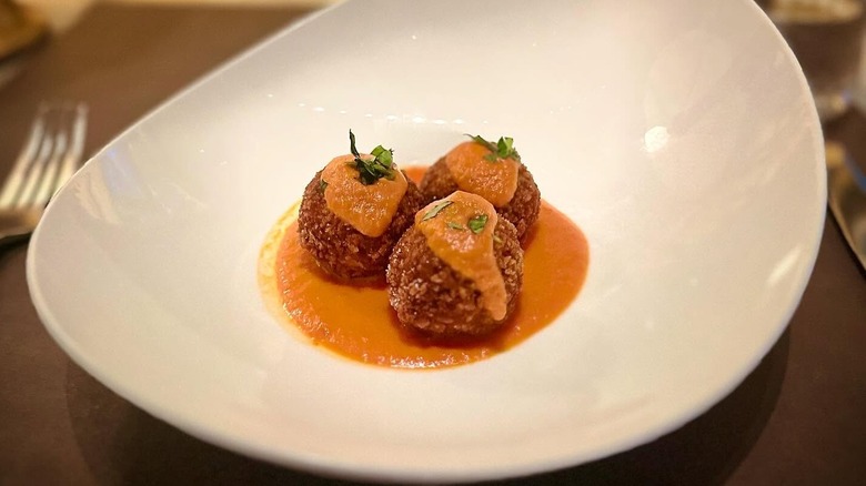 Blue Crab & Eggplant Meatballs with Fra Diavolo Sauce in a white bowl