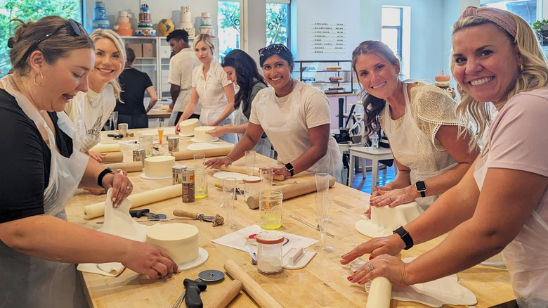 Women taking a cake baking class at Charm City Cakes