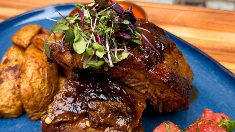 Ribs and potatoes on a blue plate at Chauhan Ale and Masala House