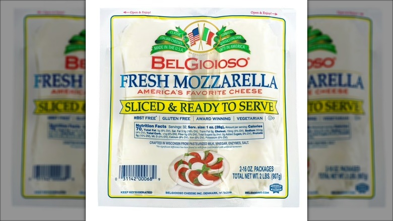Package of sliced mozzarella cheese against white background.