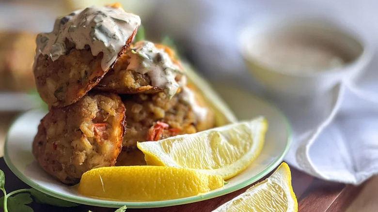 Pile of Cajun crab balls with lemon wedges