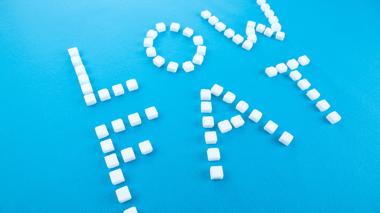 The words Low Fat spelled out with sugar cubes on blue surface