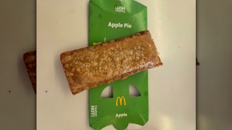 Aerial photo of a McDonald's fried apple pie sitting on its cardboard sleeve