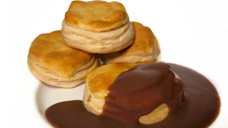 Biscuits with chocolate gravy on a white plate with a white background