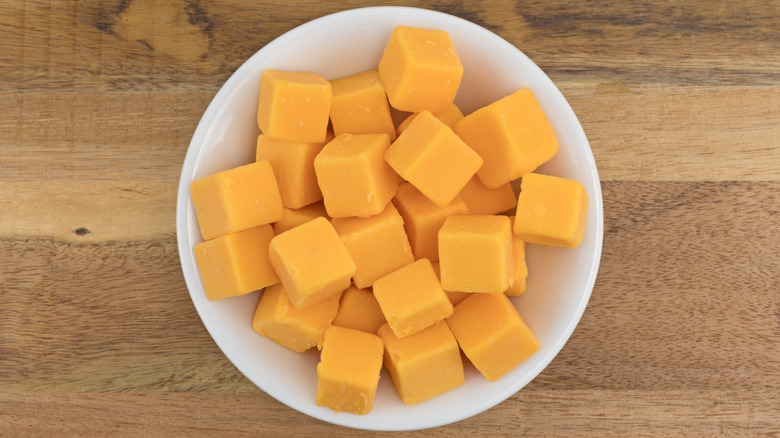 A bowl of cubed cheddar cheese
