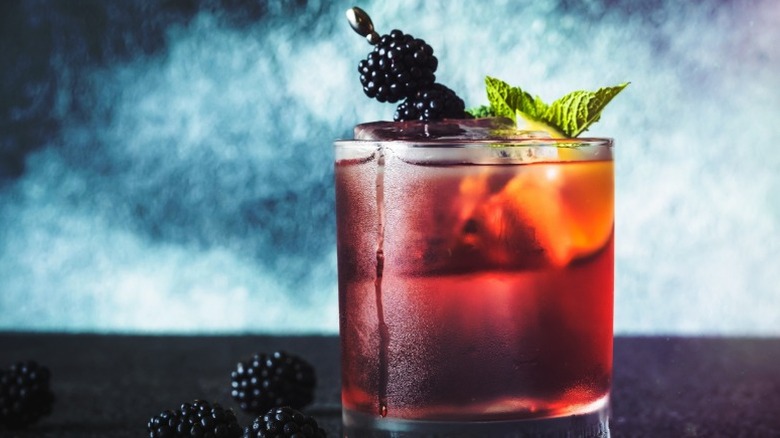 Bourbon-blackberry cocktail with blackberries on side