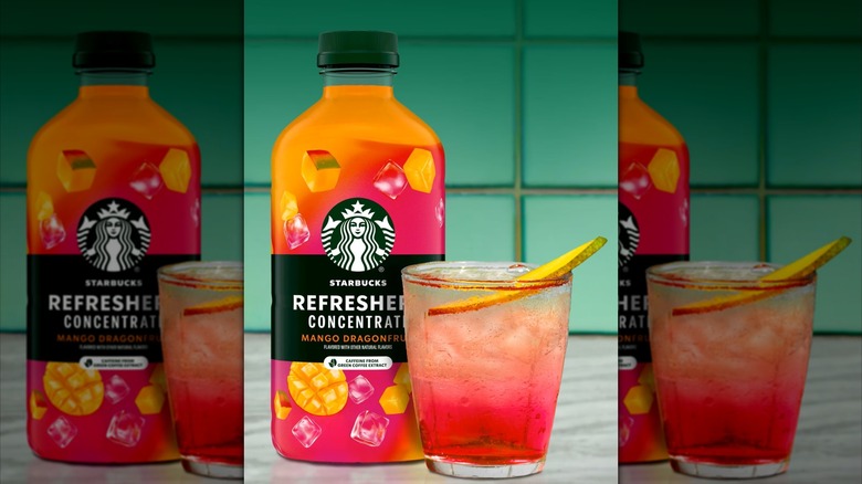 Bottle of Starbucks Refresher concentrate next to the beverage in a glass.