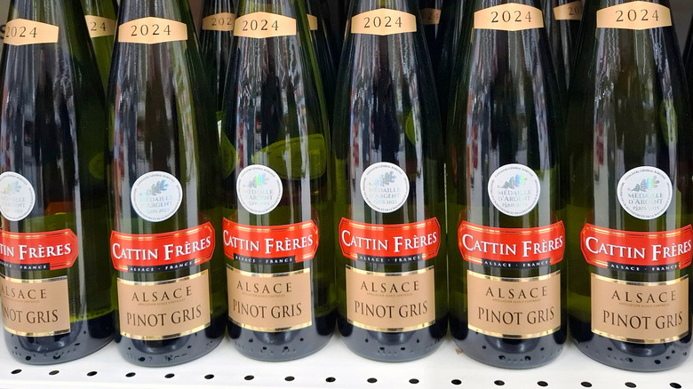 Bottles of Pinot Gris from Alsace region lined up on store shelf