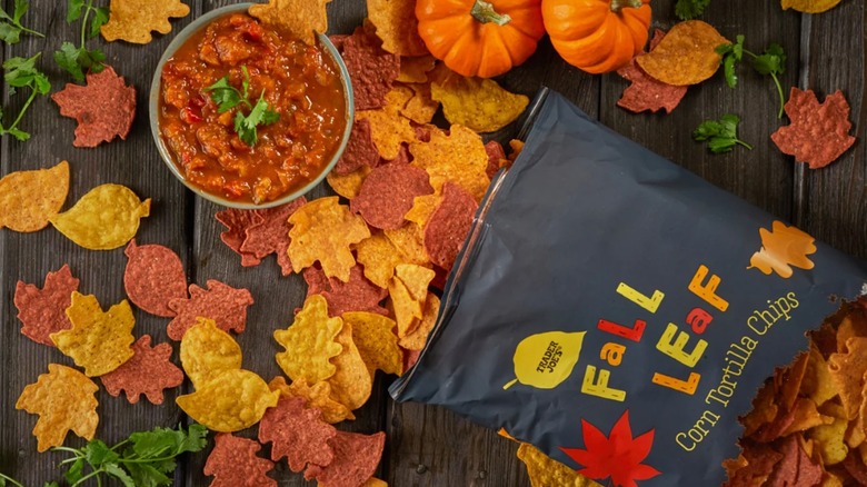 Package of Trader Joe's Fall Leaf Corn Tortilla Chips with chips scattered and salsa