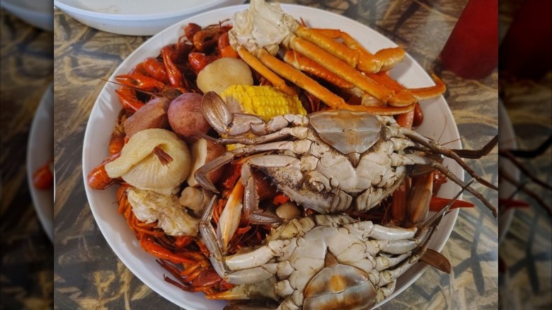 Plate of crawfish, snow crab legs, and blue crab