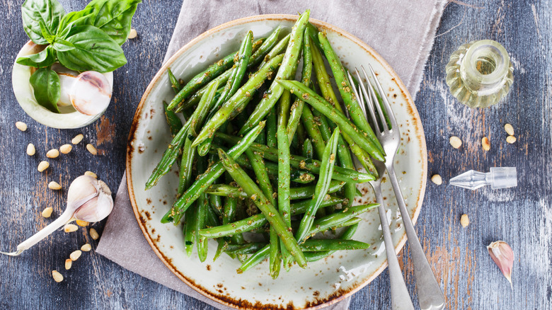 Garlic green beans on a white and brown plate