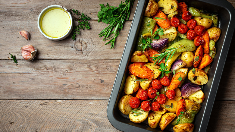 Roasted potatoes and veggies in a metal pan
