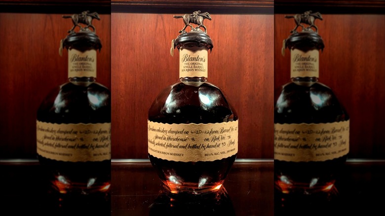Bottle of Blanton's Original Single Barrel with wood paneling background