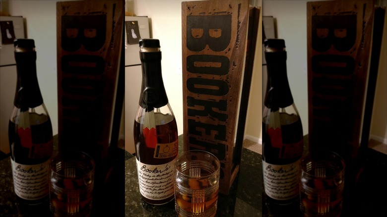 Box and bottle of Booker's bourbon with glass