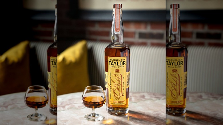 Bottle of Colonel E.H. Taylor with glass on table