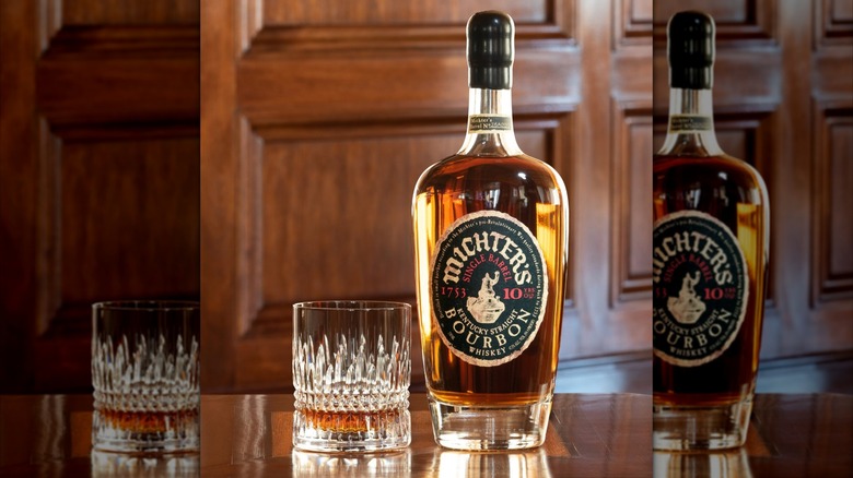 Bottle of Michter's 10-year on table with glass