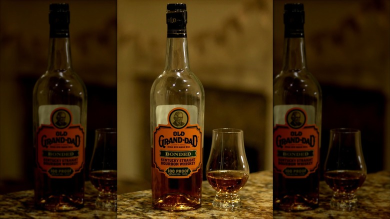 Bottle and glass of Old Grand-dad Bonded on marble table