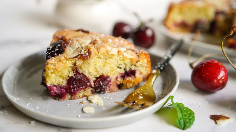 A slice of cherry almond cake on a plate