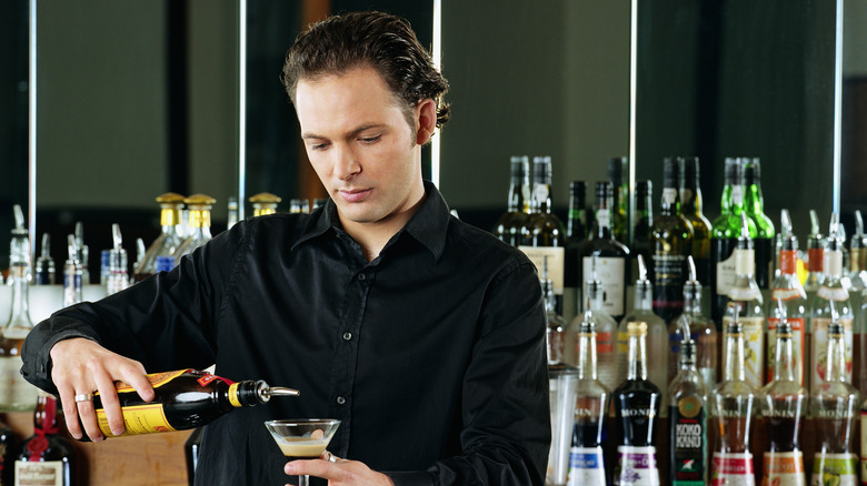 bartender pouring liquor drink