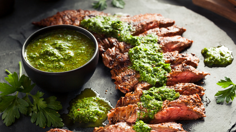 Cooked and sliced steak topped with chimmichuri sauce