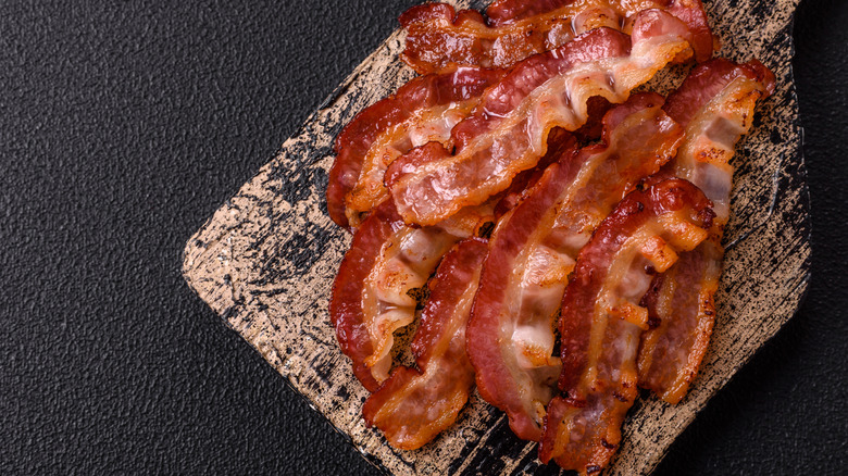 A pile of fried bacon on a serving board