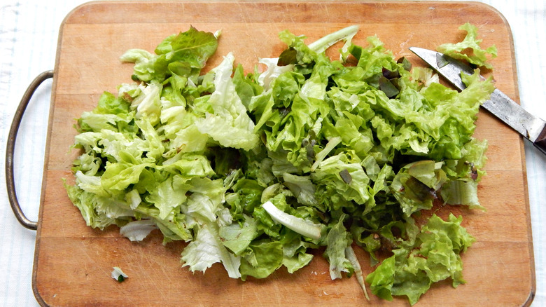 Chopped lettuce on a wooden cutting board