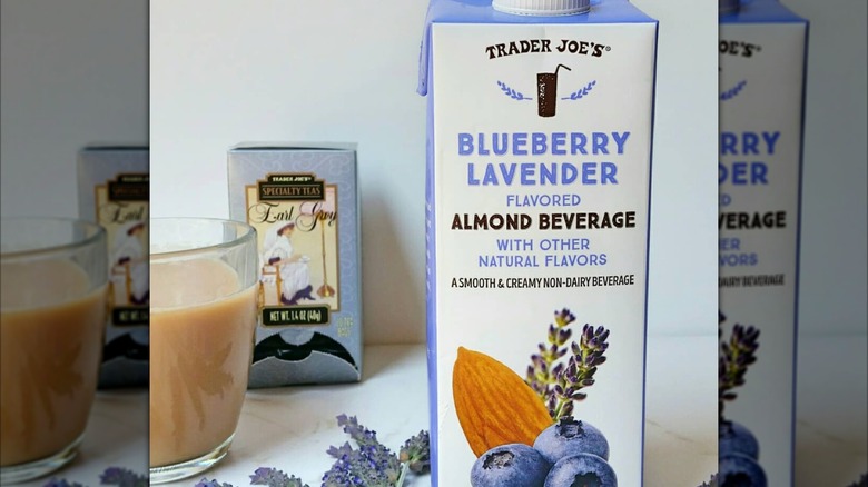 Box of Trader Joe's blueberry lavendar almond beverage next to a mug of earl gray tea