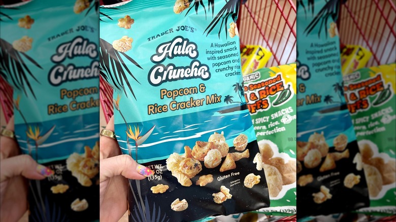 woman's hand holding a bag of Trader Joe's Hula Cruncha popcorn mix