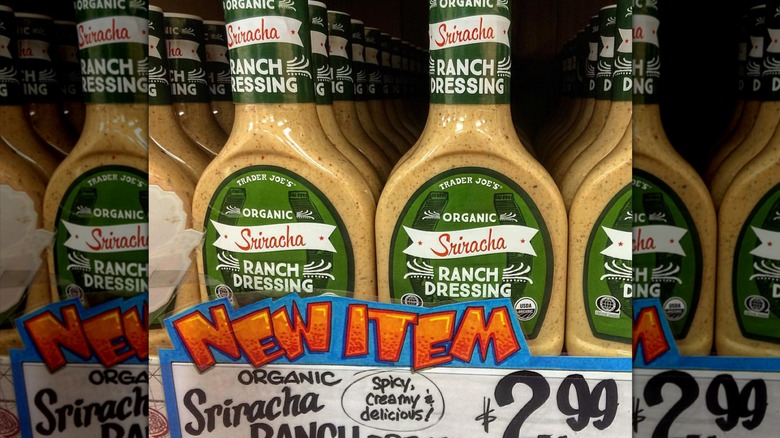 bottles of Organic Sriracha Ranch Dressing on a shelf at Trader Joe's