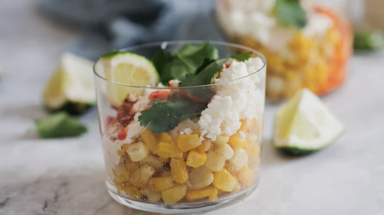 Glass cup filled with corn and toppings