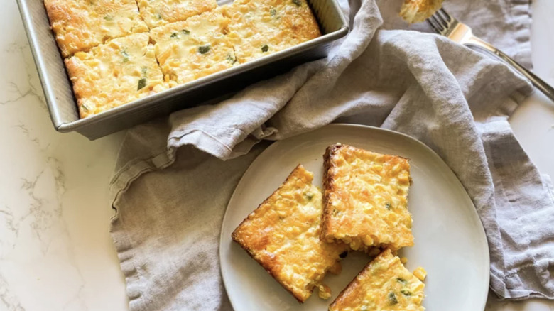 Baking dish and plate with creamy cornbread casserole
