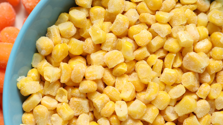 Close-up of frozen corn kernels in a blue bowl
