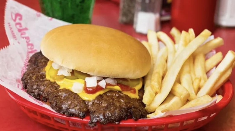 smash burger with cheese alongside fries