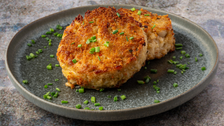 Two golden brown crab cakes on a plate