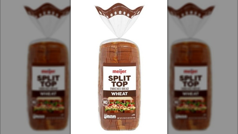 Loaf of split top wheat bread in plastic bag.