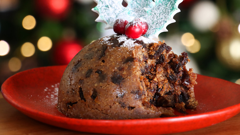 Christmas plum pudding on red plate