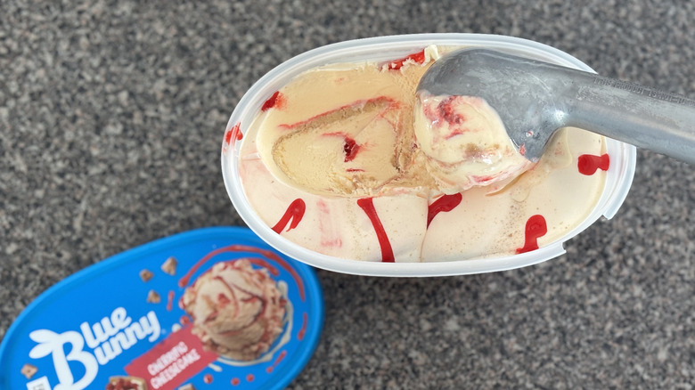 cheesecake ice cream with cherry swirls and graham swirl in ice cream scoop