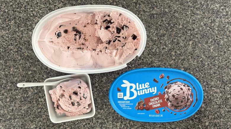 top-down view of carton of pink ice cream with chocolate chunks